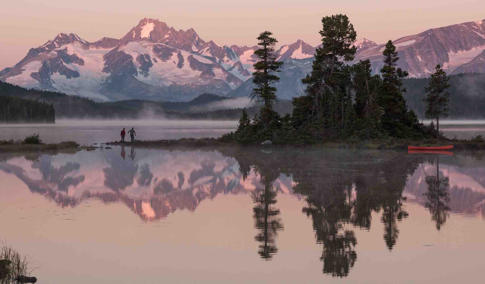 Canoeists at Nuk Tessli Wilderness Experience on Whitton Lake with view of the Coast Mountains